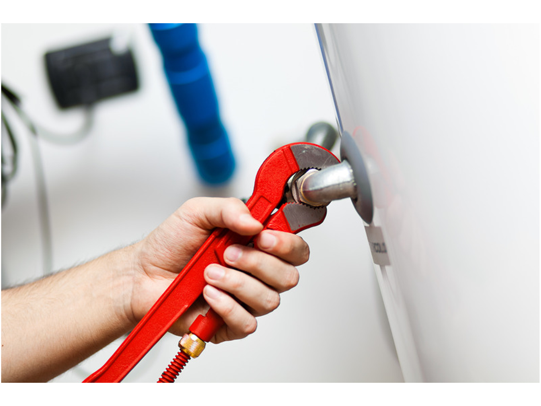 A plumber servicing a hot water system